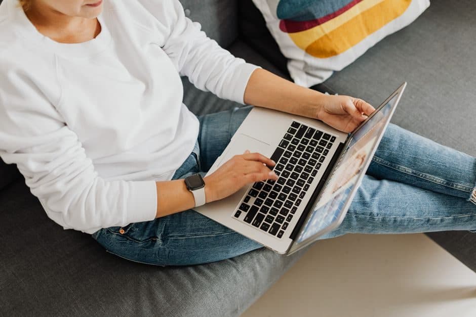 A person searching for information on a laptop at home